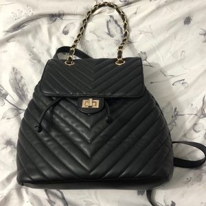 Black quilted backpack with gold hardware